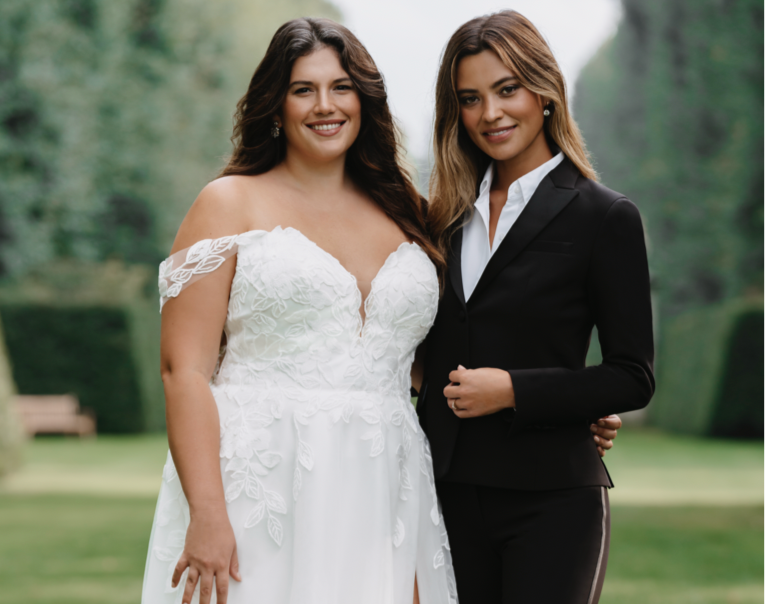 Lesbian couple wedding photo with one bride in a suit and the other in a dress